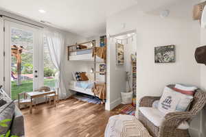 Bedroom with light wood-type flooring, access to outside, and recessed lighting