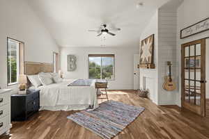 Bedroom featuring vaulted ceiling, wood finished floors, and ceiling fan