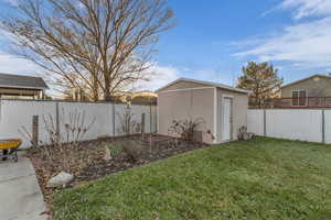 Fenced backyard with a storage unit