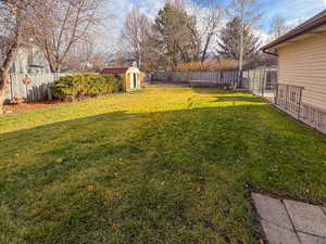 Fenced backyard with a storage shed