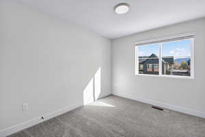 Unfurnished room with carpet and baseboards