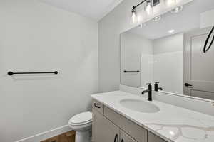 Full bathroom with vanity, a shower, and dark wood finished floors