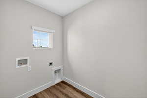 Laundry area featuring dark wood-style flooring, washer hookup, and hookup for an electric dryer