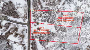 Snowy aerial view featuring property boundaries highlighted