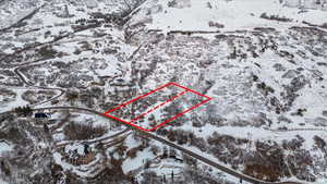 Snowy aerial view featuring property boundaries highlighted