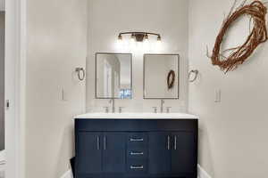 Bath featuring double vanity.