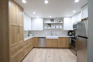 Kitchen featuring open shelves, stainless steel appliances, and recessed lighting