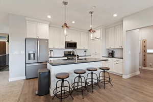 Floor-to-ceiling cabinets, quartz countertops, slate SS appliances, gas range, soft-close cabinetry, & Murphy door to the large pantry