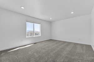 Unfurnished room with carpet and recessed lighting