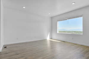 Empty room featuring light wood-style floors and recessed lighting