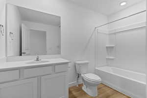 Bathroom with vanity,  shower combination, and light wood-type flooring