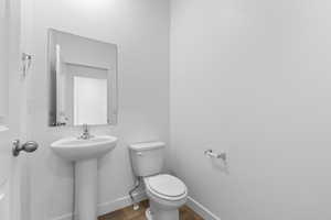 Bathroom with baseboards and wood finished floors