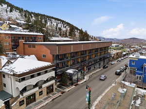 Aerial view of a mountain backdrop and apartment complex