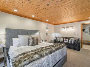 Bedroom with wooden ceiling, recessed lighting, and carpet flooring