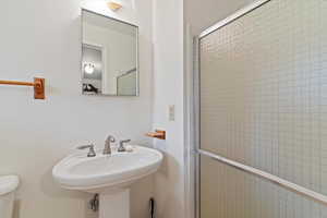Bathroom featuring a shower stall and toilet