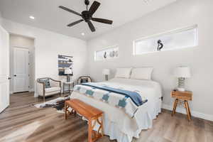 Bedroom featuring light wood finished floors, ceiling fan, and recessed lighting