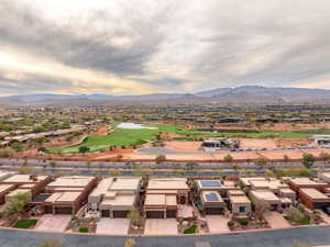 Aerial view of residential area featuring a golf club and a mountain backdrop