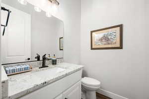 Bathroom with vanity and dark wood-type flooring