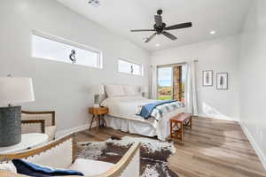 Bedroom with light wood-type flooring, a ceiling fan, and recessed lighting
