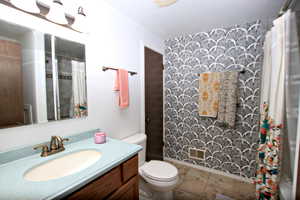 Full bath featuring vanity and a shower with shower curtain