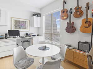 Dining area off kitchen with desk area behind it.