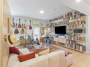 Living room featuring floor to ceiling buit-in bookshelves