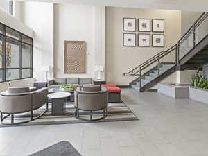 Community lobby with stairs and a high ceiling