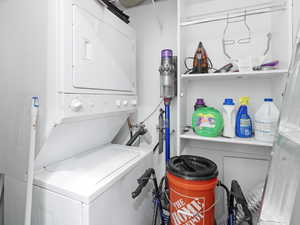 Laundry room with stacked washer and dryer