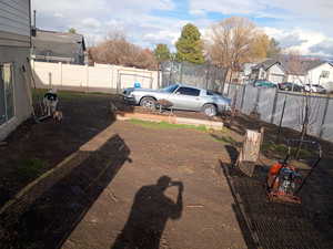 Fenced backyard with a trampoline and a residential view