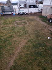 View of yard with a trampoline