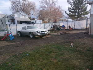View of yard featuring a trampoline and a vegetable garden