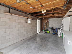 Garage featuring concrete block wall