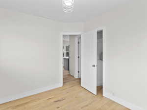 Unfurnished bedroom featuring baseboards and light wood-style flooring