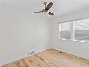 Unfurnished room featuring light wood-type flooring and ceiling fan