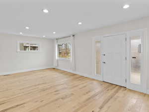 Entrance foyer featuring light wood finished floors and recessed lighting