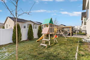 View of play area featuring a patio, a fenced backyard, and a deck