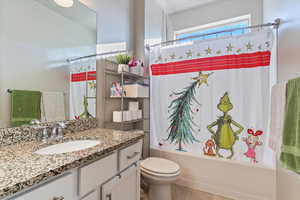 Full bathroom with shower / bath combo with shower curtain and vanity