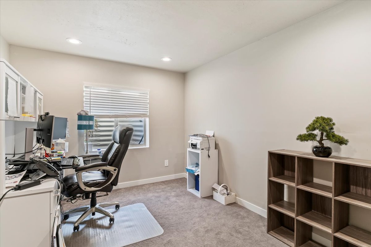 Home office with light carpet and recessed lighting