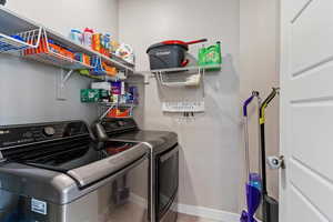 Washroom with baseboards and washer and dryer