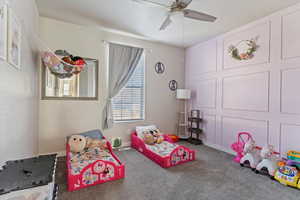 Recreation room with carpet floors and a ceiling fan