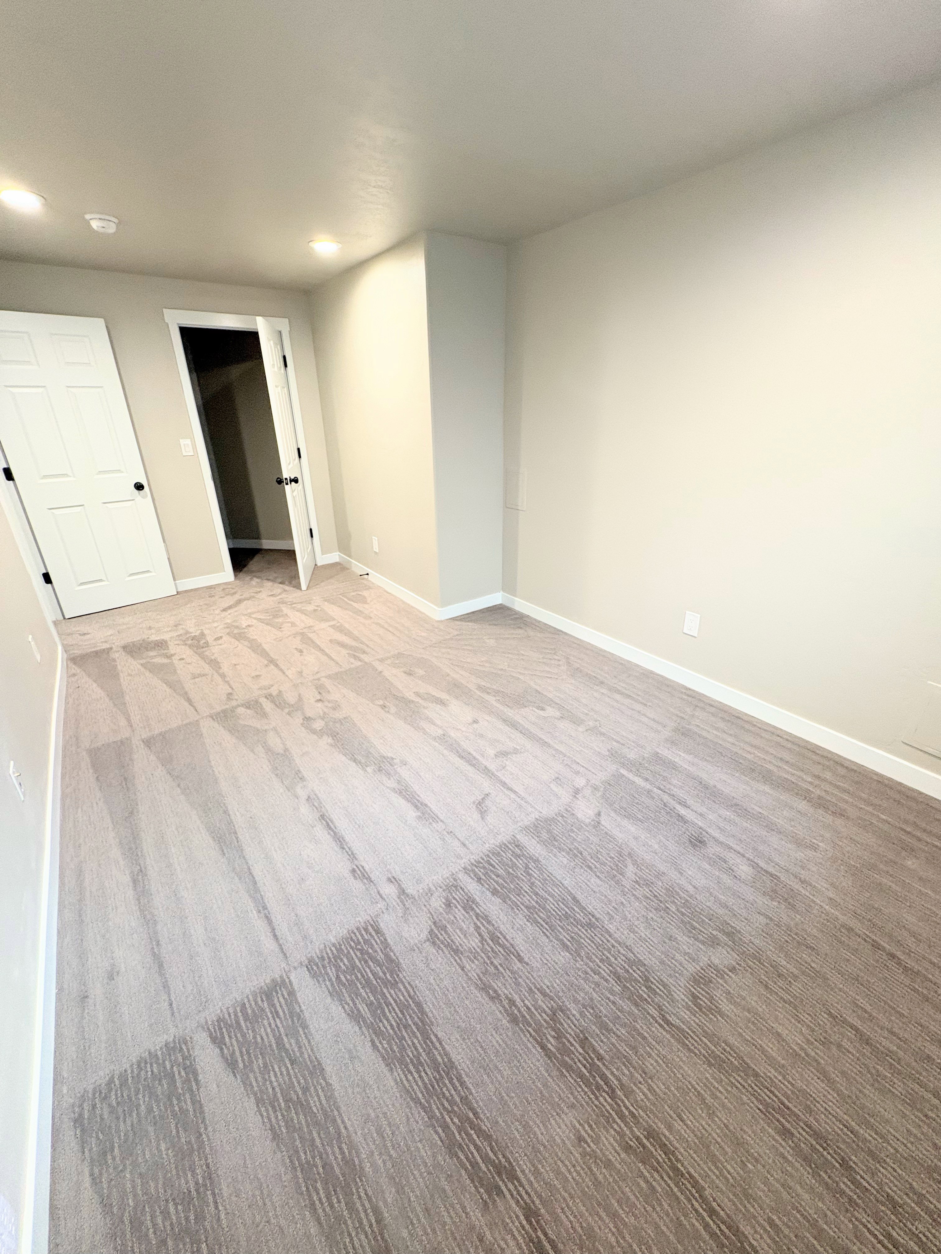 Unfurnished room with light carpet and recessed lighting