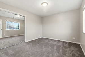 Unfurnished bedroom featuring a closet and carpet floors