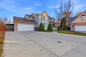 Traditional-style house with concrete driveway and brick siding
