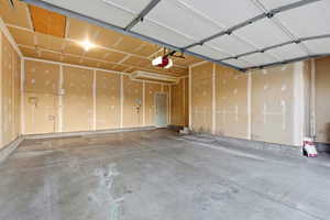 Garage featuring a garage door opener