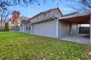 Rear view of house with a patio area and a playground
