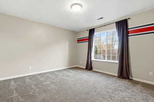 Unfurnished room with light carpet and a textured ceiling