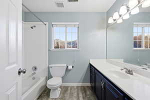 Bathroom with shower / bath combination, vanity, and light wood finished floors