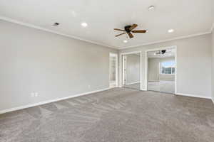 Unfurnished bedroom featuring ornamental molding, carpet, a ceiling fan, recessed lighting, and ensuite bath