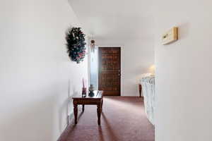 Hall with carpet floors and baseboards