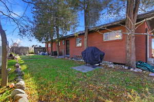 View of side of property featuring a patio and brick siding